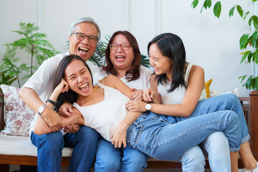 4 pax family laughing candid creative in studio