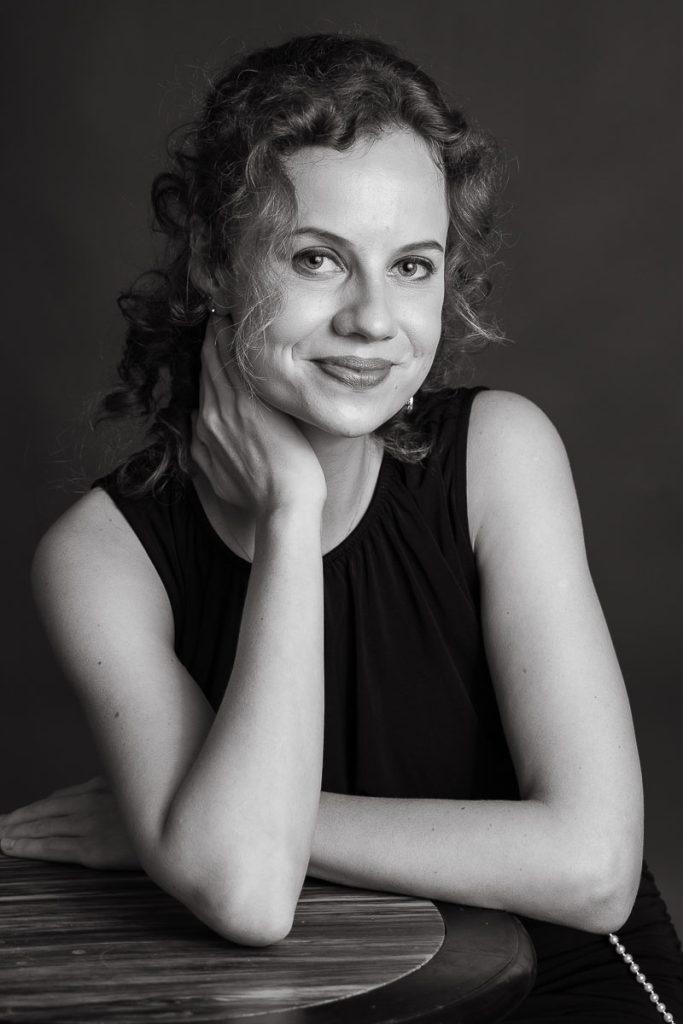 hands on neck smiling portrait black and white