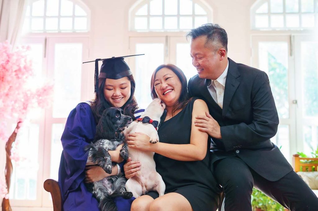 candid family graduation 2 pet dogs