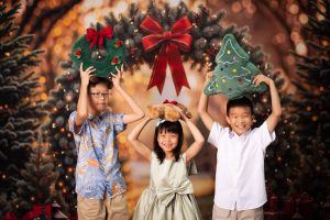 laughing children celebrating christmas in photo studio singapore