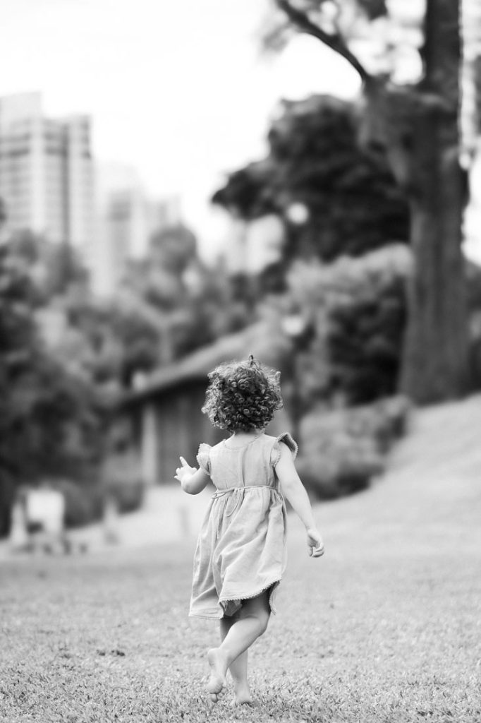 Timeless Black and white image of a little girl running in a meadow care-freely