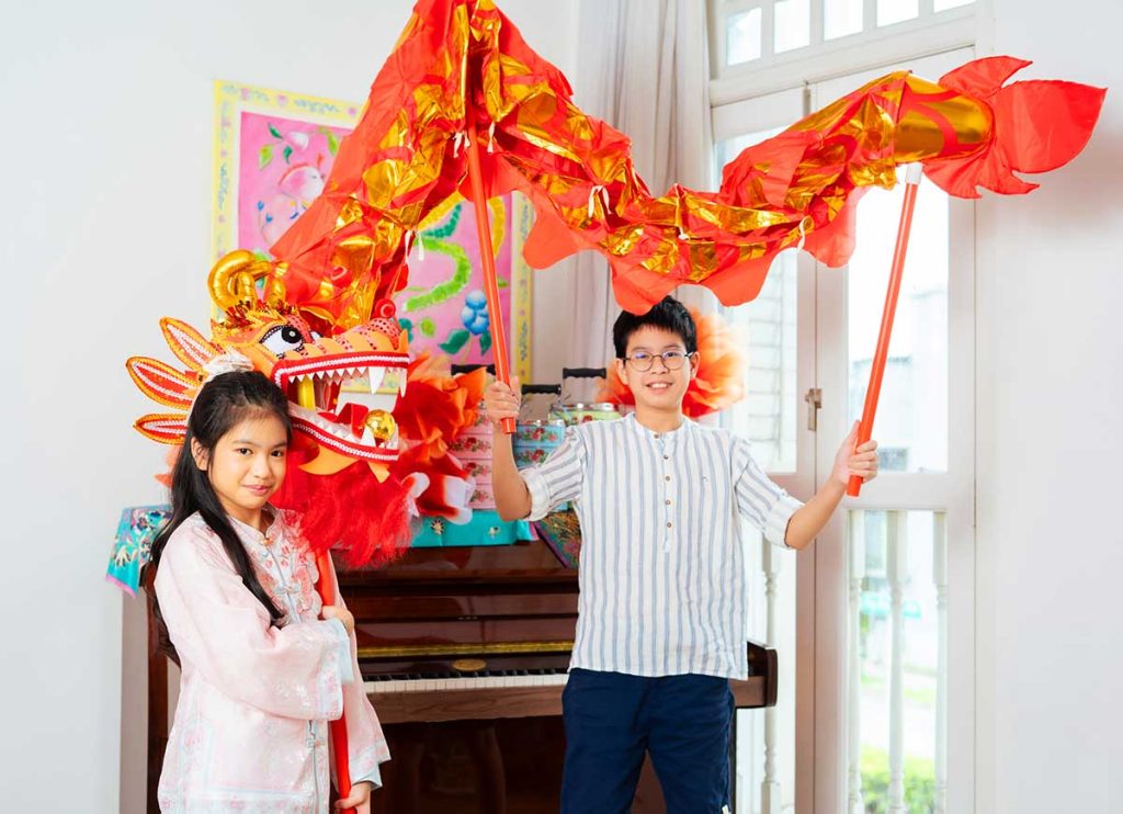 sibling playing dragon dance CNY 2026 photography studio singapore fun candid natural