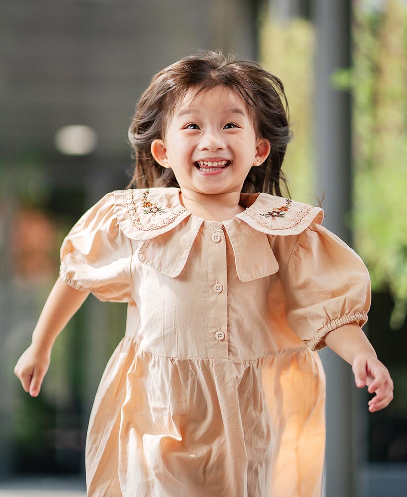 Sensory friendly photography session in Singapore showing a genuine smile from a child with autism and developmental delay